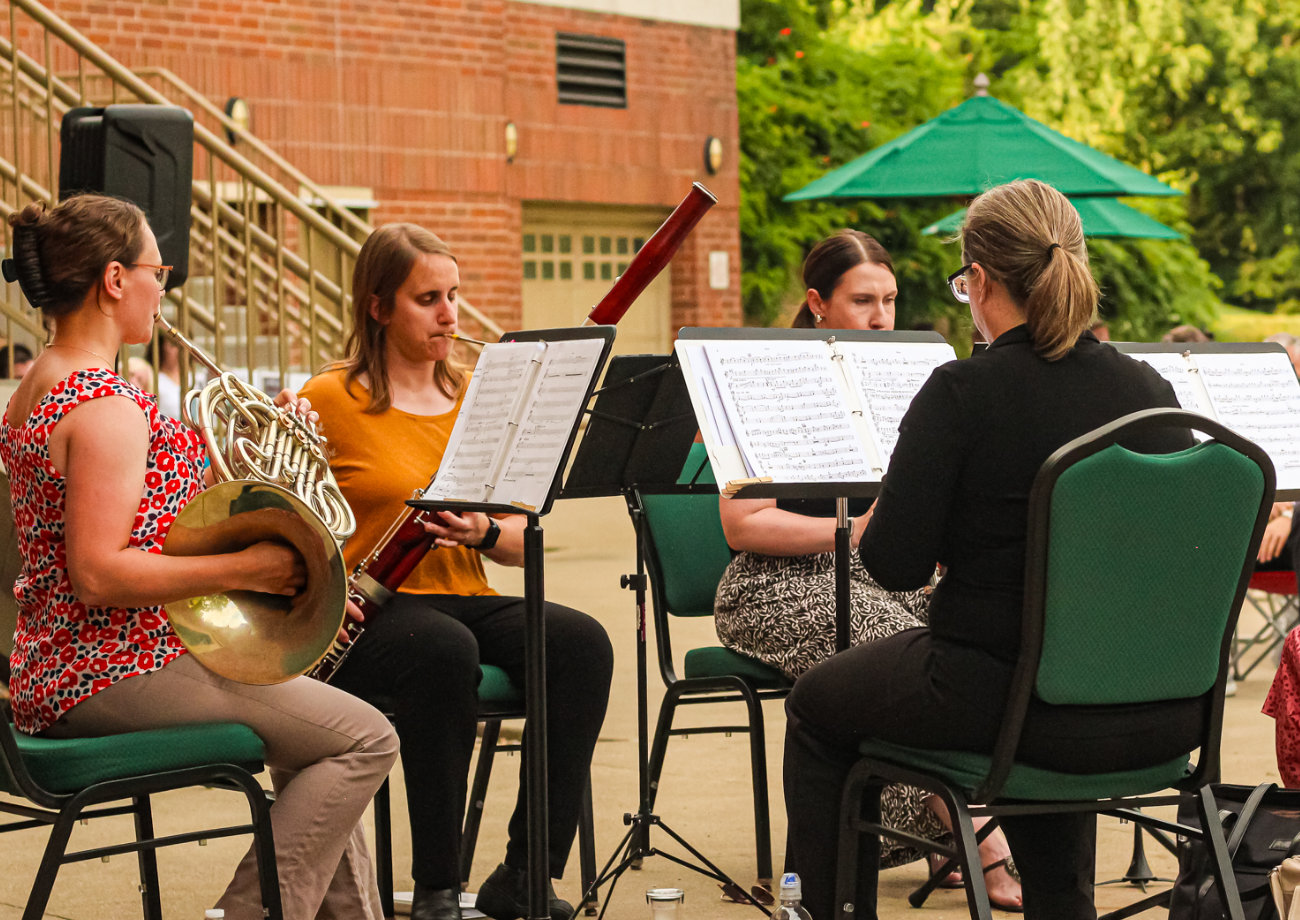 Orchestra Performers seated on chairs